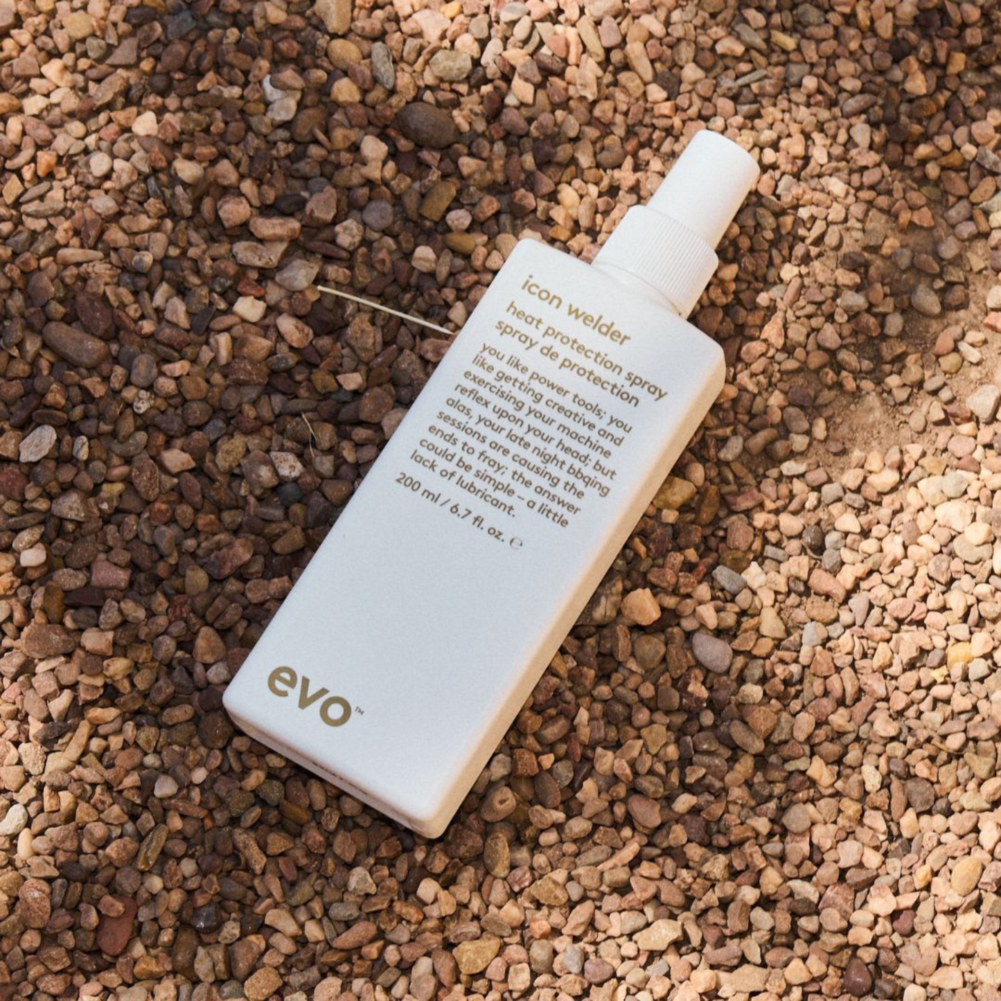 evo icon welder heat protection spray bottle on a textured brown surface