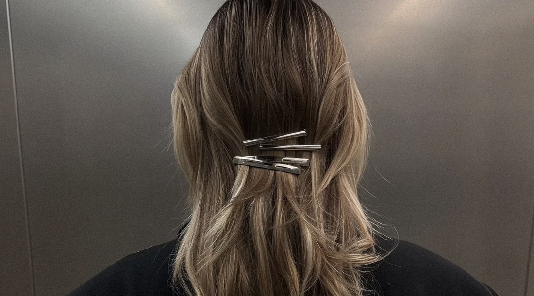 Woman with Blonde hair wearing 4 silver bar clips at her nape