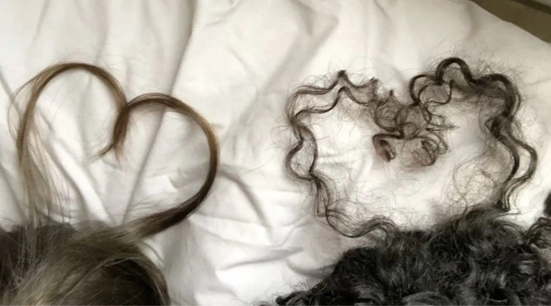 Two different hair textures in the shapes of hearts - straight and curly strands