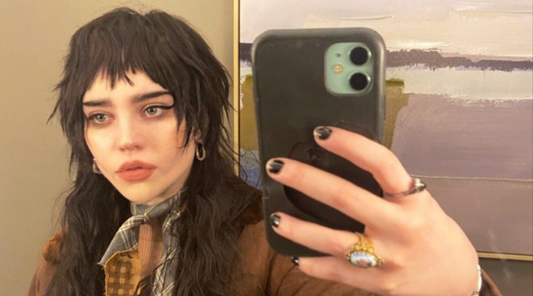 woman with choppy micro bangs taking a selfie