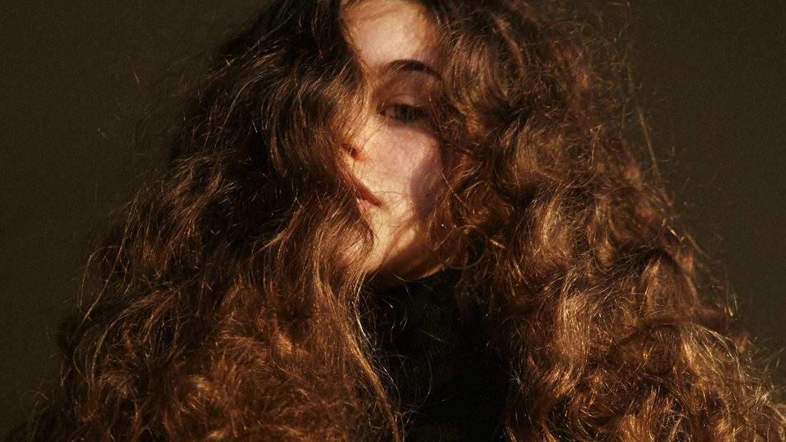 woman with warm brunette natural textured hair 