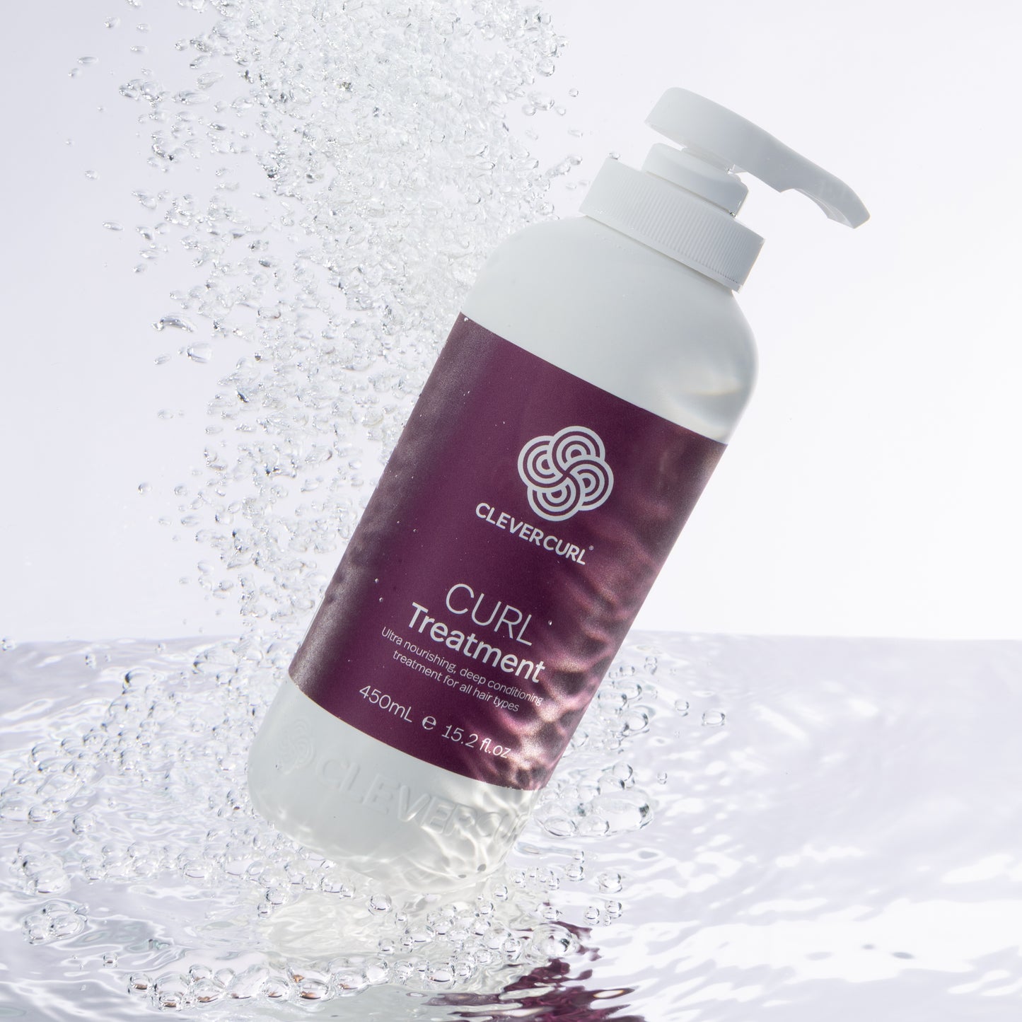 Clever Curl Curl Treatment 450ml bottle with a white pump on a water background