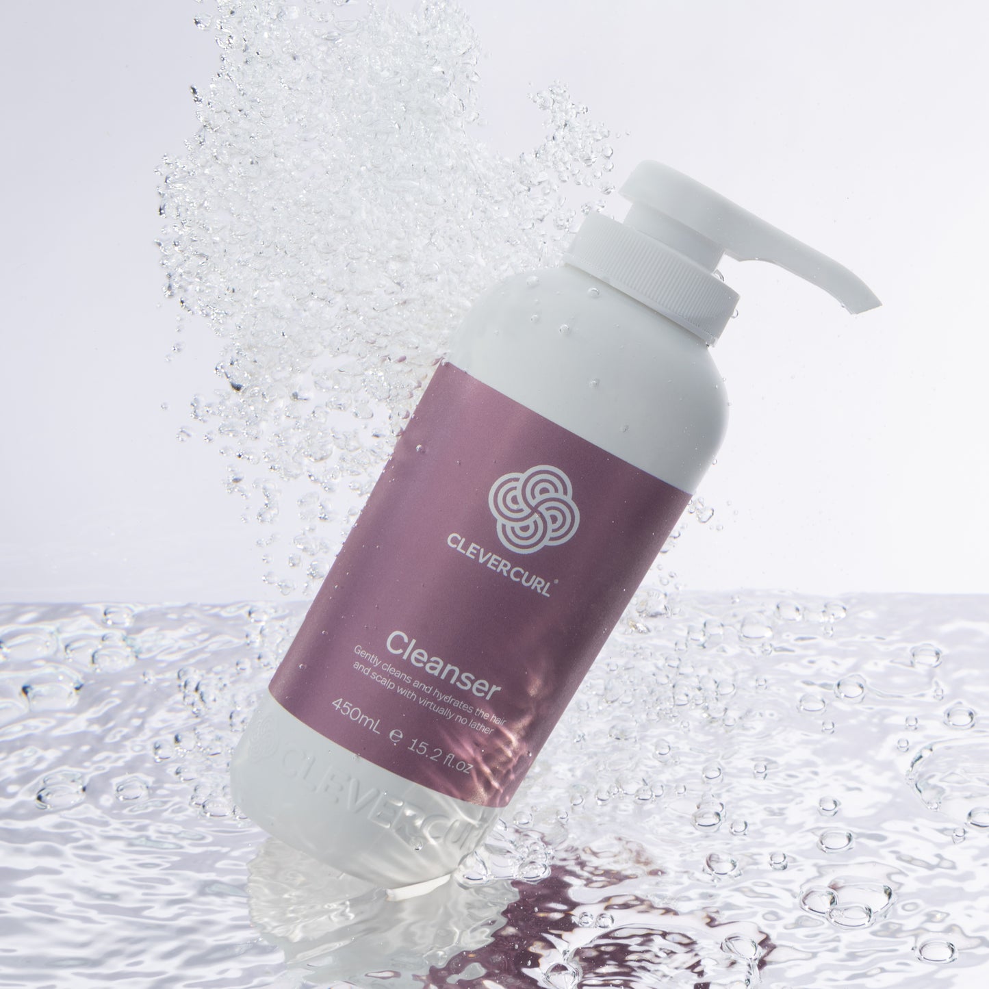 Clever Curl Cleanser 450ml bottle with pump on a textured white background