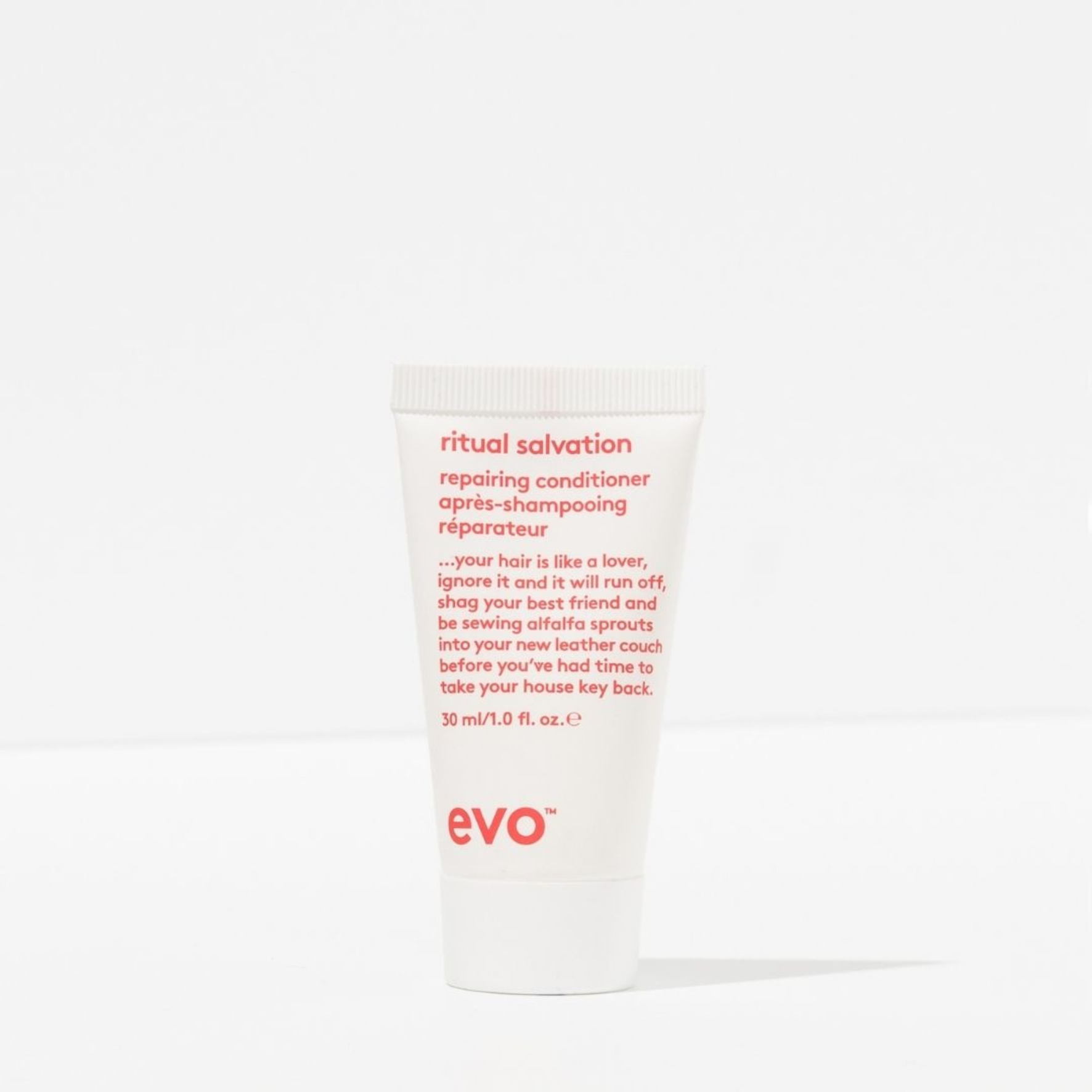 White tube of evo ritual salvation repairing conditioner with red text on a white background
