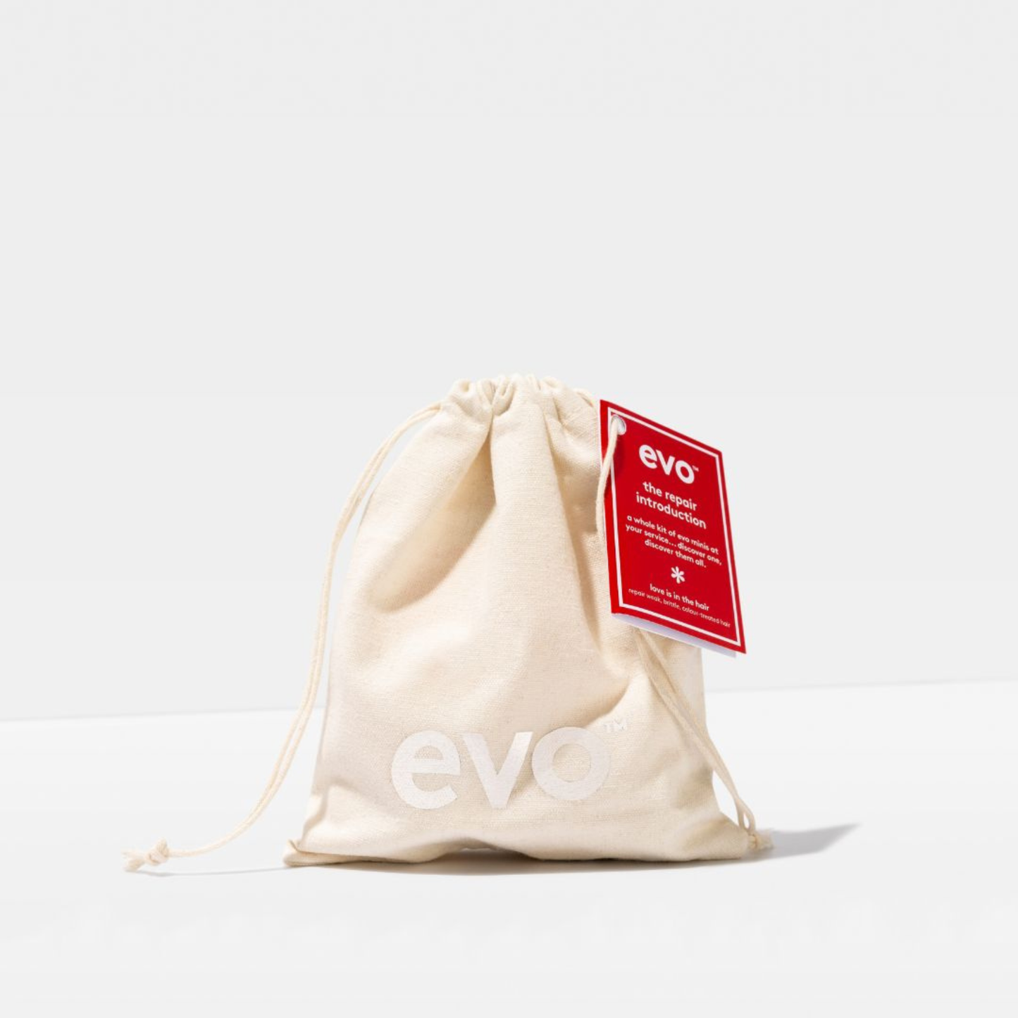 Evo The Repair Introduction Gift Set in Beige drawstring bag with Evo logo and tag on a white background