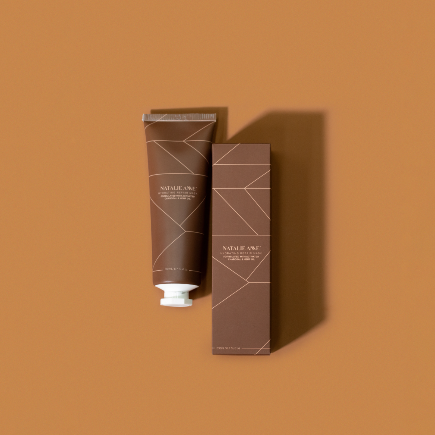 Natalie Anne Charcoal Repair Mask with warm brown background