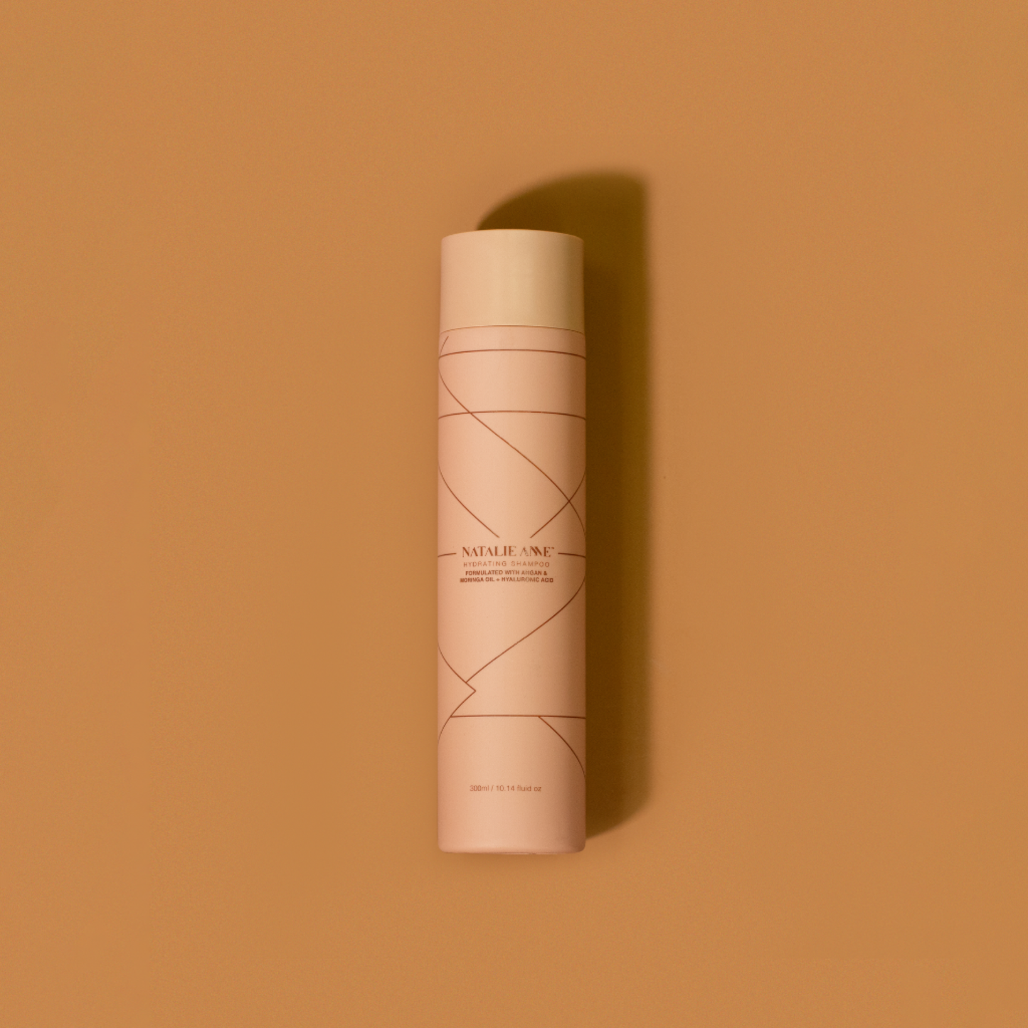 Natalie Anne Hydrating Shampoo on warm brown background