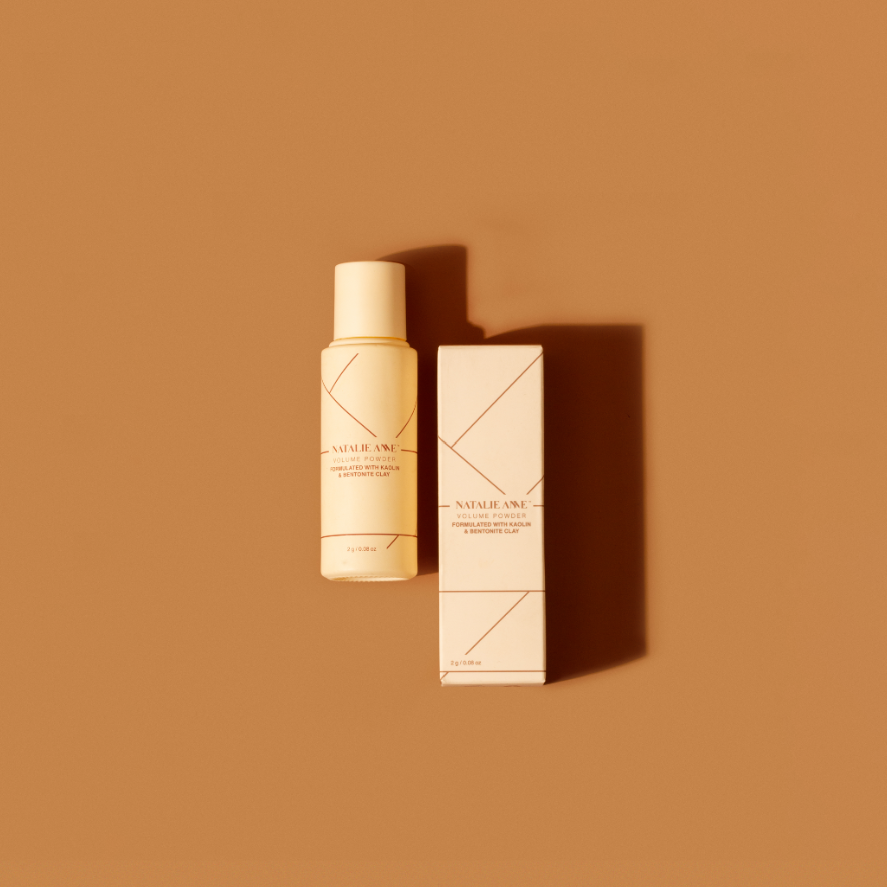 Natalie Anne Volumising Powder with warm brown background