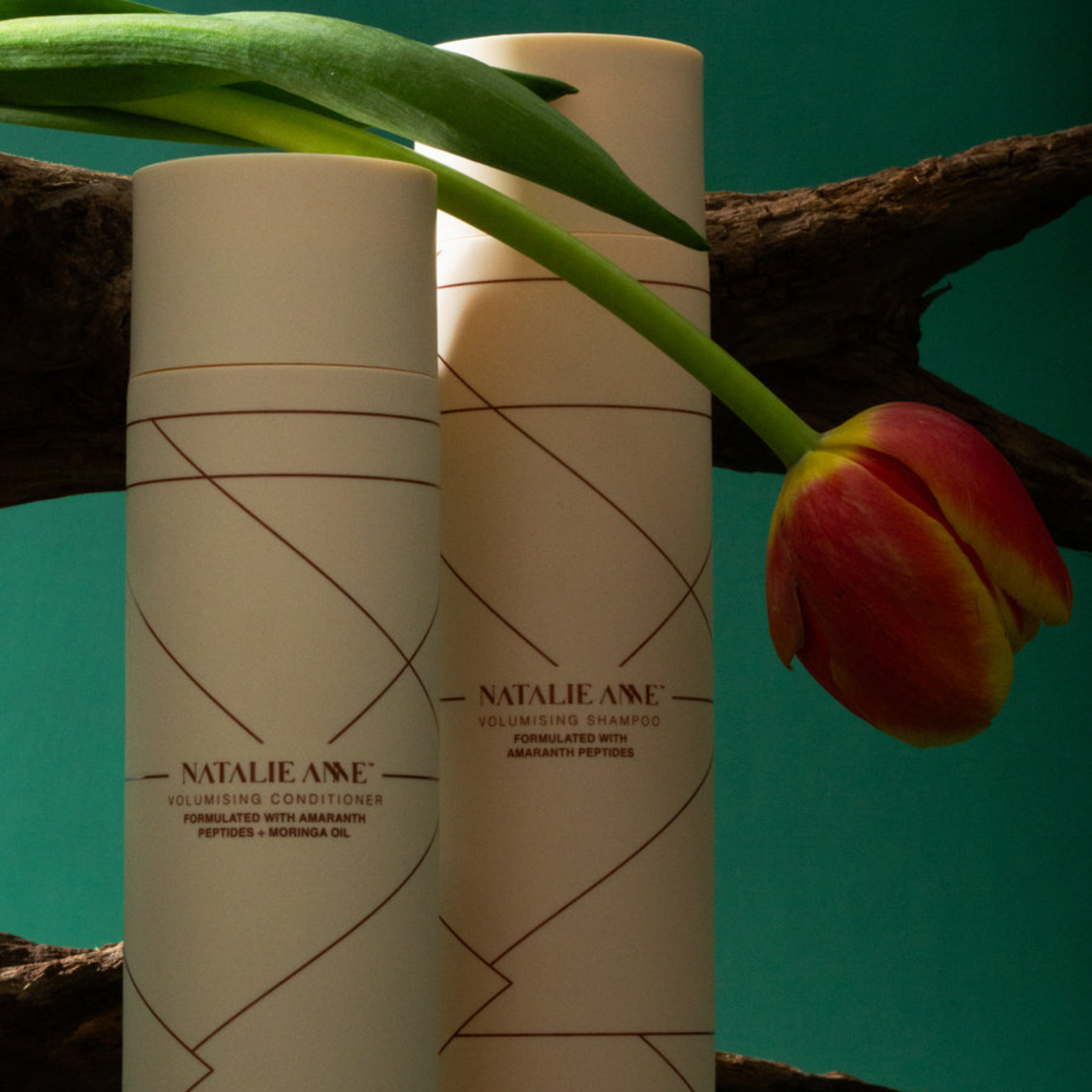  Natalie Anne volumising shampoo and conditioner with a tulip flower on a natural background.